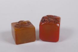 A Chinese amber soapstone seal with Buddha head decoration, and another similar, 3 x 3cm