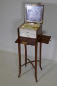 A mahogany vanity chest with fitted interior and two drawers, the top with a mirror, bears label