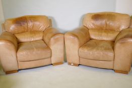 A pair of contemporary leather easy chairs