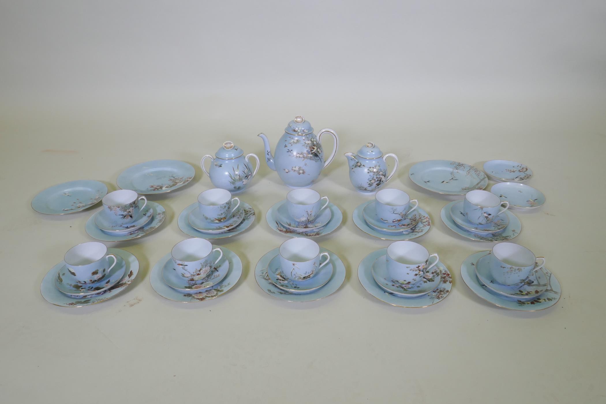A Japanese Meiji period hand painted eggshell porcelain part tea service, comprising a tea pot, milk