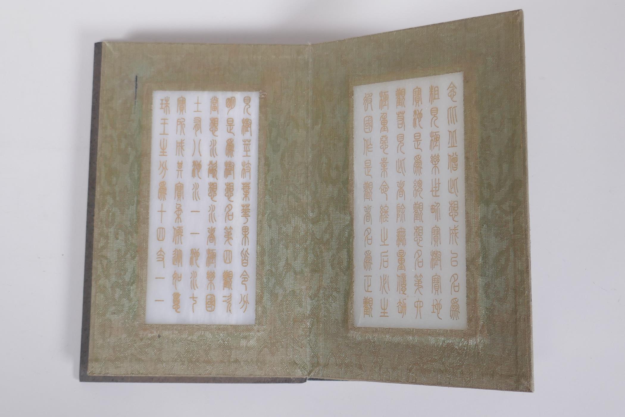 A Chinese fabric and wood bound book containing white jade tablets with chased and gilt character - Image 5 of 6