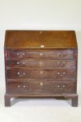 A Georgian mahogany bureau with four graduated drawers, the fall front fitted with pigeon holes