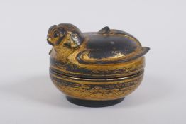 An antique oriental gilt and black lacquer box in the form of a bird, 9cm diameter