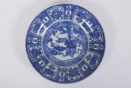 A C19th Chinese blue and white porcelain export ware dish decorated with a figure in a landscape,