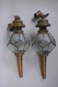 A pair of antique brass and glass polyhedral wall lanterns, 52cm long