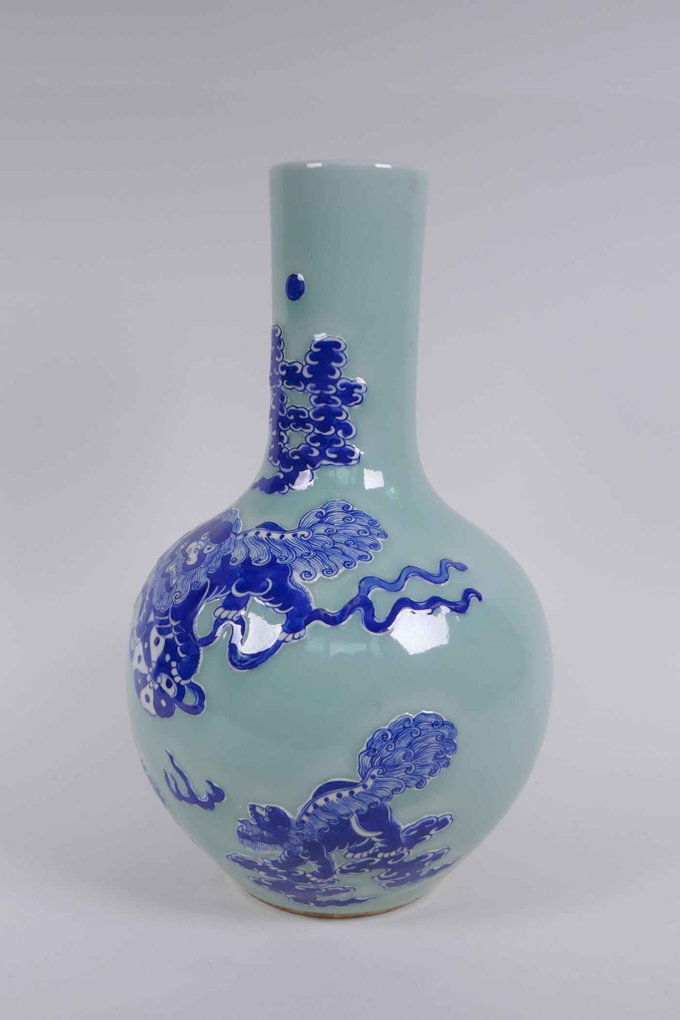 A Chinese celadon ground porcelain bottle vase with raised blue and white kylin decoration, 35cm - Image 2 of 6