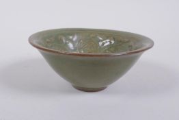 A Chinese Yaozhou kiln olive glazed bowl decorated with a floral design, 10cm diameter