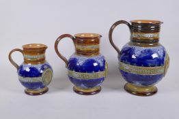 A set of three Queen Victoria Diamond Jubliee Doulton Lambeth graduated stoneware jugs, all three