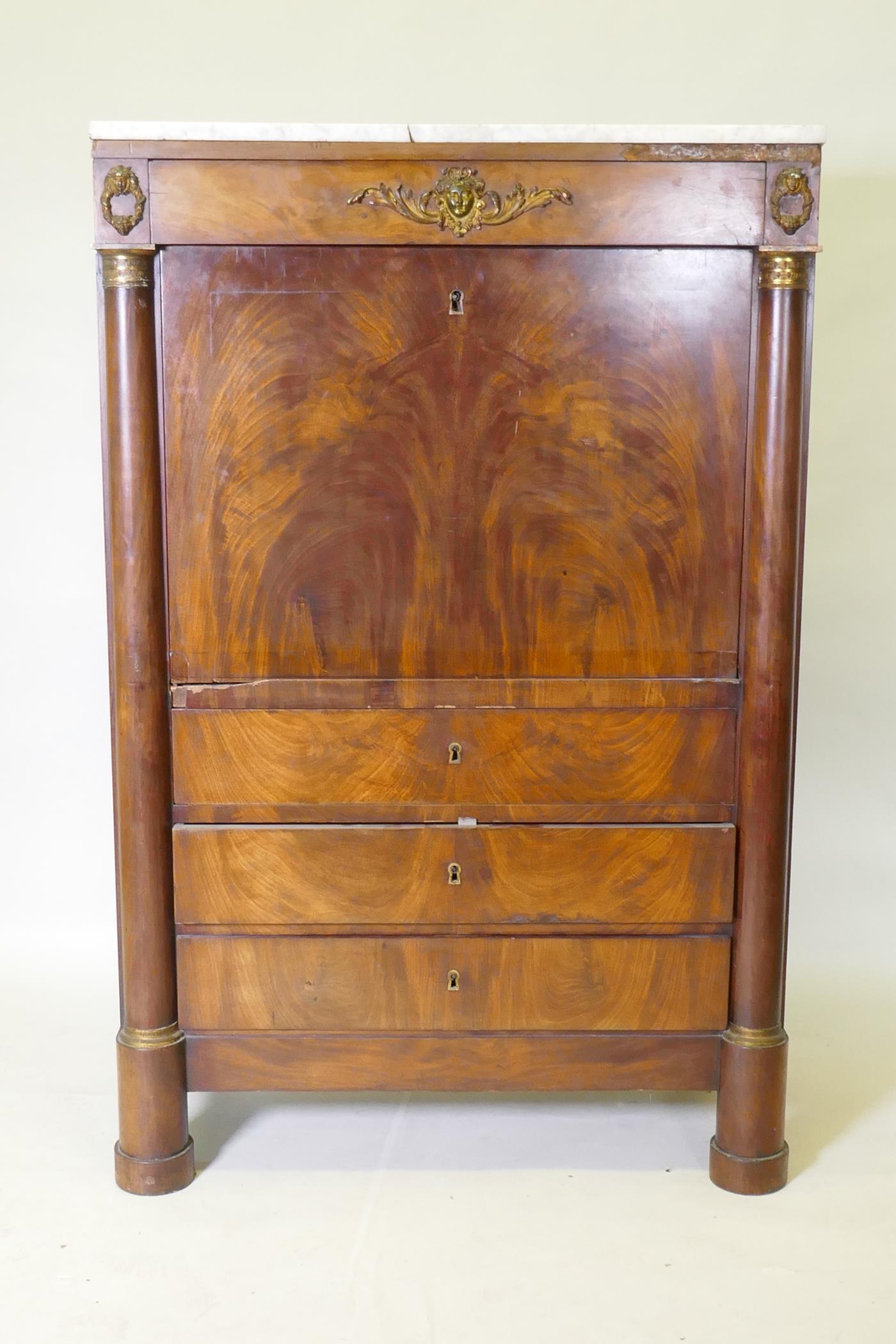A C19th continental figured mahogany secretaire a abattant with ormolu mounts and marble top over