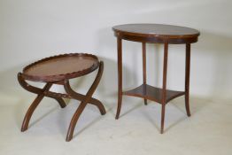 A Victorian mahogany two tier occasional table with oval top, raised on sabre supports, 70 x 43 x
