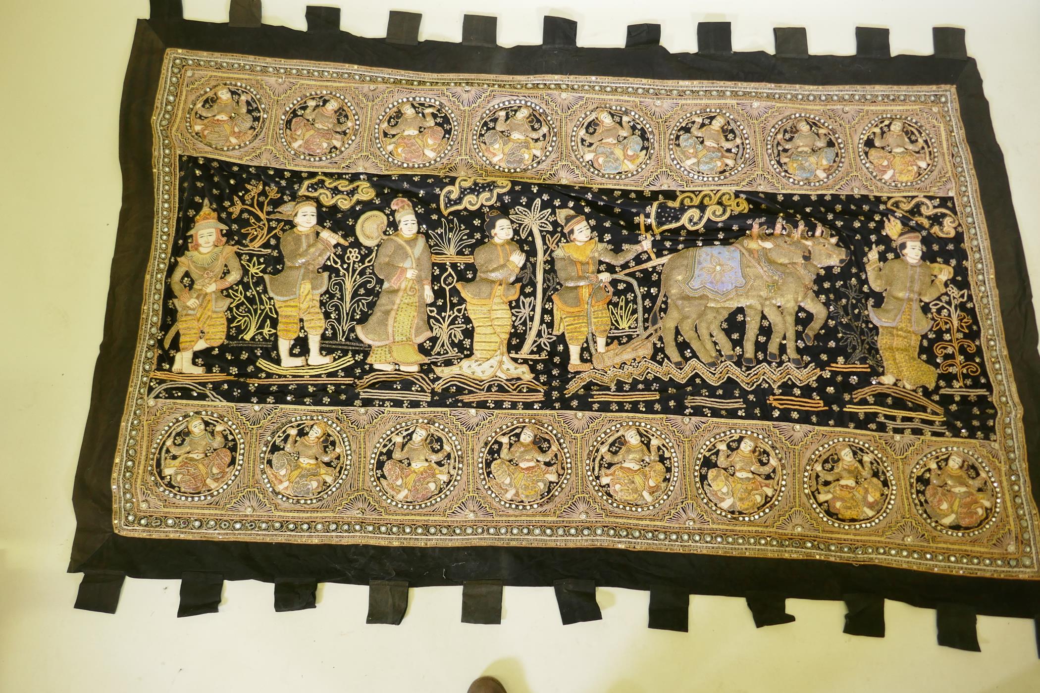 An oriental stumpwork wall hanging depicting a procession with oxen and plough, 213 x 150cm