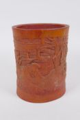 A Chinese bamboo brush pot with carved decoration of Lo-han in a landscape, 16cm high