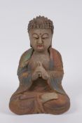 A Sino Tibetan carved and painted wood figure of Buddha, 22cm high