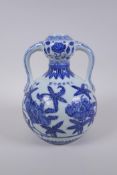 A blue and white porcelain two handled garlic head shaped vase with floral decoration, Chinese