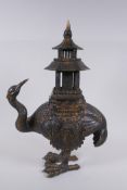 An oriental gilt bronze censer and cover in the form of a crane with a two section pagoda 45cm high