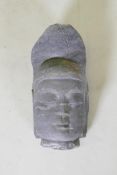 An oriental carved basalt Buddha head, 41cm high