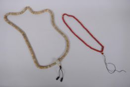 A string of bone mala beads, and a string of coral mala beads, longest 108cm