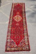 A rich red ground full heavy pile Iranian runner, AF, 104 x 365cm