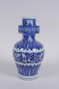 A Chinese blue and white porcelain vase with two lug handles and scrolling floral decoration, Xuande