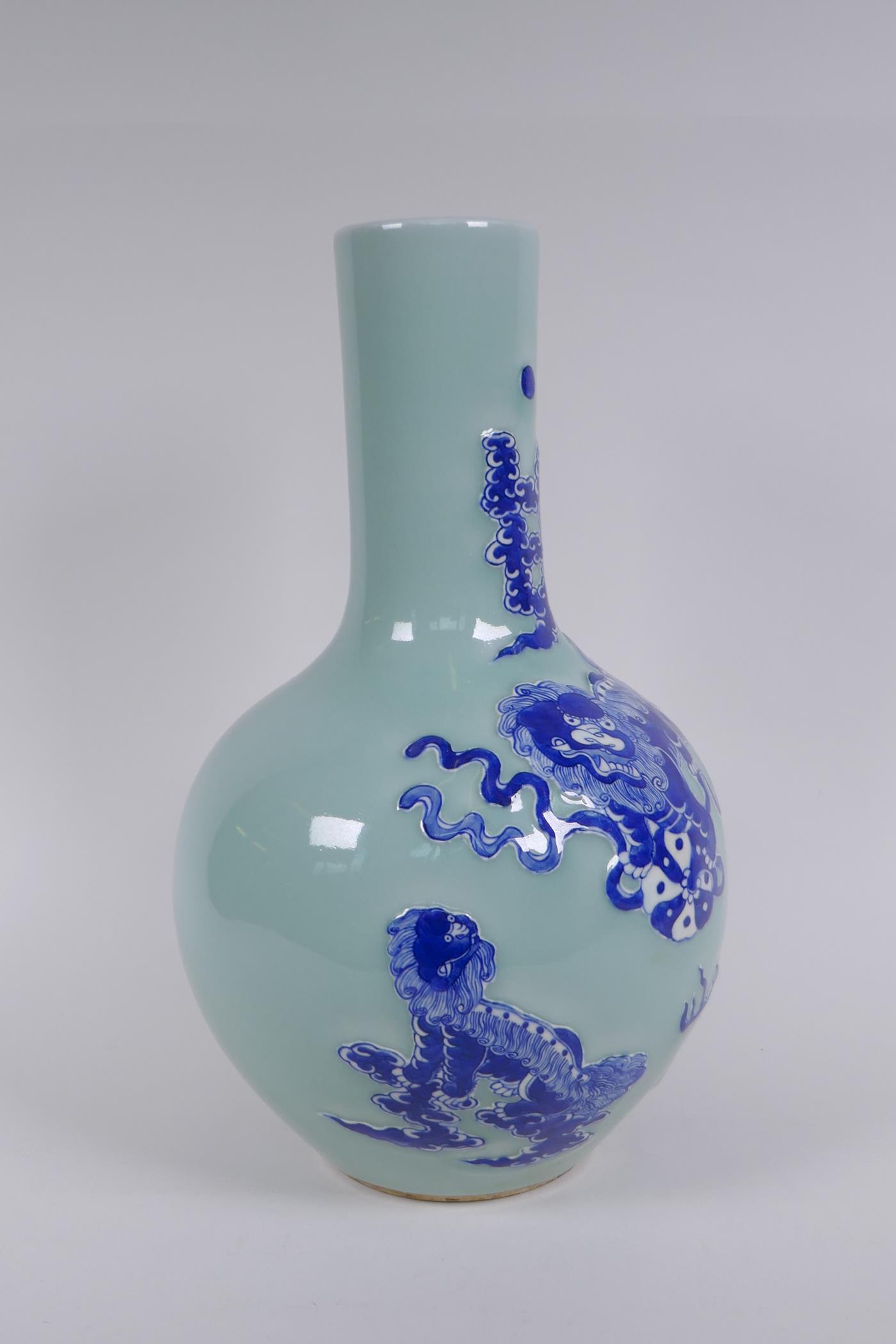 A Chinese celadon ground porcelain bottle vase with raised blue and white kylin decoration, 35cm - Image 4 of 6