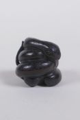 A Japanese carved boxwood netsuke in the form of a snake, 2cm