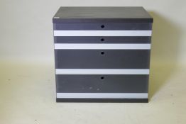 A black ash chest with four graduated glass front drawers, 72 x 54 x 67cm