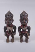 A pair of African Yoruba tribe carved wood Ere Ibeji figures, 28cm high