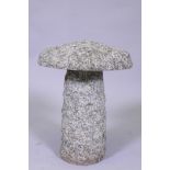 A small granite saddle stone, 30cm diameter, 37cm high