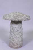 A small granite saddle stone, 30cm diameter, 37cm high