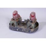 A C19th painted cast iron foot scraper in the form of a pair of lions, 44cm wide, 28cm high