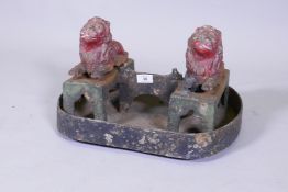 A C19th painted cast iron foot scraper in the form of a pair of lions, 44cm wide, 28cm high