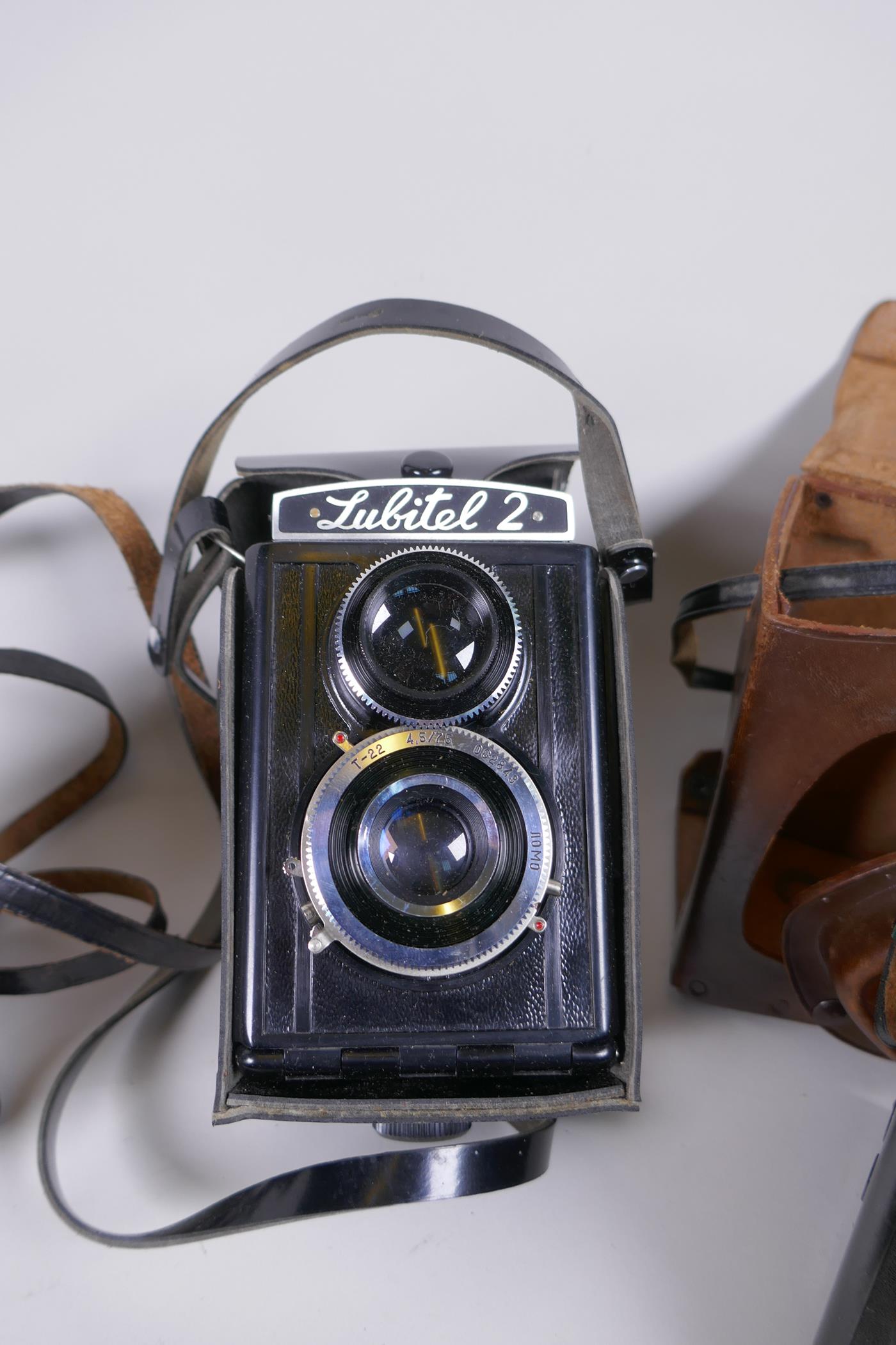 Three vintage medium format film cameras including two Voigtlander Brilliant Compur and Lubitel 2, a - Image 3 of 9