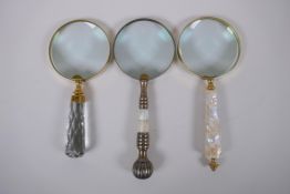 Three brass magnifying glasses with mother of pearl glass and metal handles, 25cm
