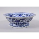 A Chinese blue and white porcelain footed bowl decorated with dragons and lotus flowers, 21cm