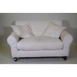 A Habitat two seater sofa with cream coloured linen covers, 140cm wide