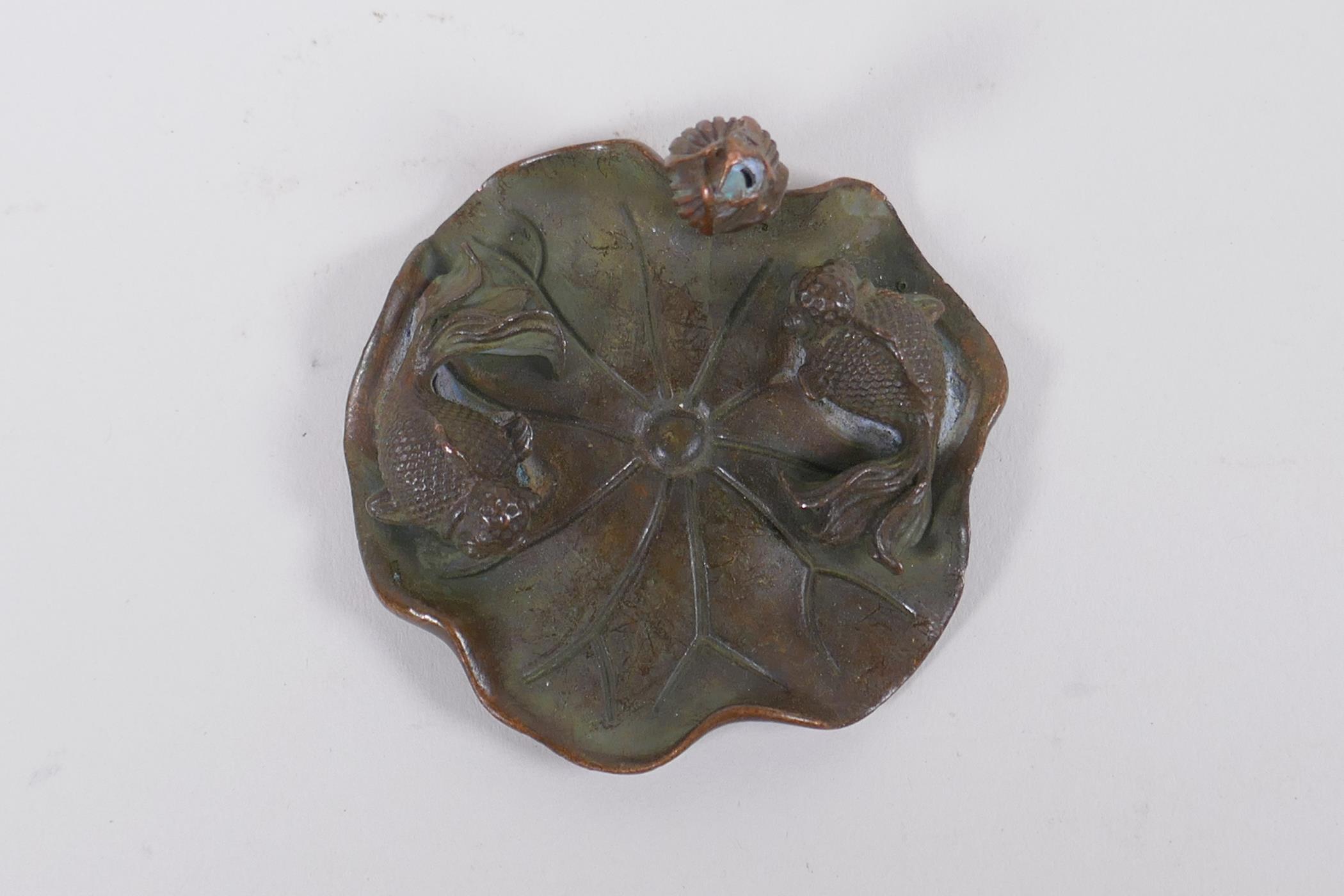 An oriental bronze incense stick holder in the form of a goldfish on a lily pad, 6cm diameter - Image 2 of 3