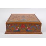 A Chinese lacquered box of square form with chased painted and gilt decoration of dragons, birds,