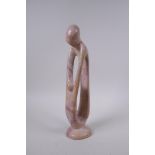 A Kenyan carved and polished Kisii stone figure group in the form of a mother and child, 23cm high