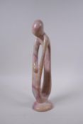A Kenyan carved and polished Kisii stone figure group in the form of a mother and child, 23cm high