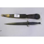 A third pattern Commando dagger, marked William Rodgers, Sheffield, in a leather sheath with brass