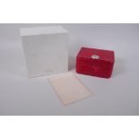 An empty Omega wrist watch case in red with an accompanying wallet and outer box, 16 x 17 cm