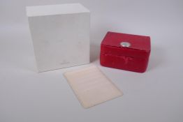 An empty Omega wrist watch case in red with an accompanying wallet and outer box, 16 x 17 cm
