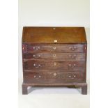 A Georgian mahogany bureau with four graduated drawers, the fall front fitted with pigeon holes