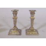 A pair of Victorian Adam style silver candlesticks, London 1894, maker's mark rubbed, 16cm high