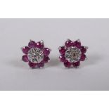 A pair of white gold diamond and ruby stud earrings