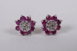 A pair of white gold diamond and ruby stud earrings