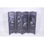 An antique Japanese four fold black lacquer screen with inlaid mother of pearl and abalone