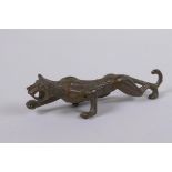 A Japanese style bronze okimono in the form of a prowling leopard, 11cm long