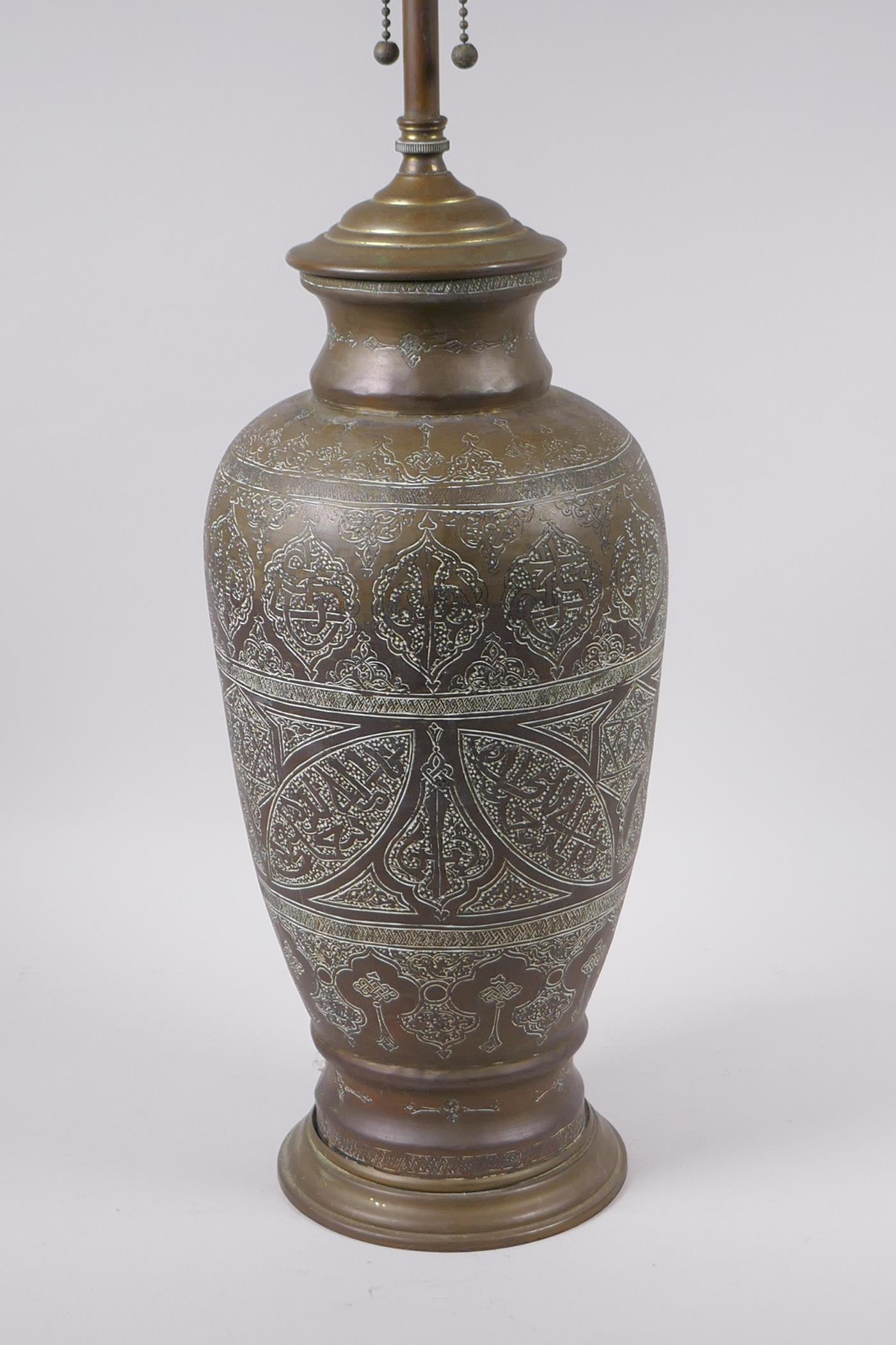 An Islamic brass vase with chased script decoration, converted to a table lamp, 67cm high - Image 4 of 6