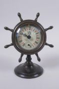 A bronze desk clock in the form of a ship's wheel, 15cm high